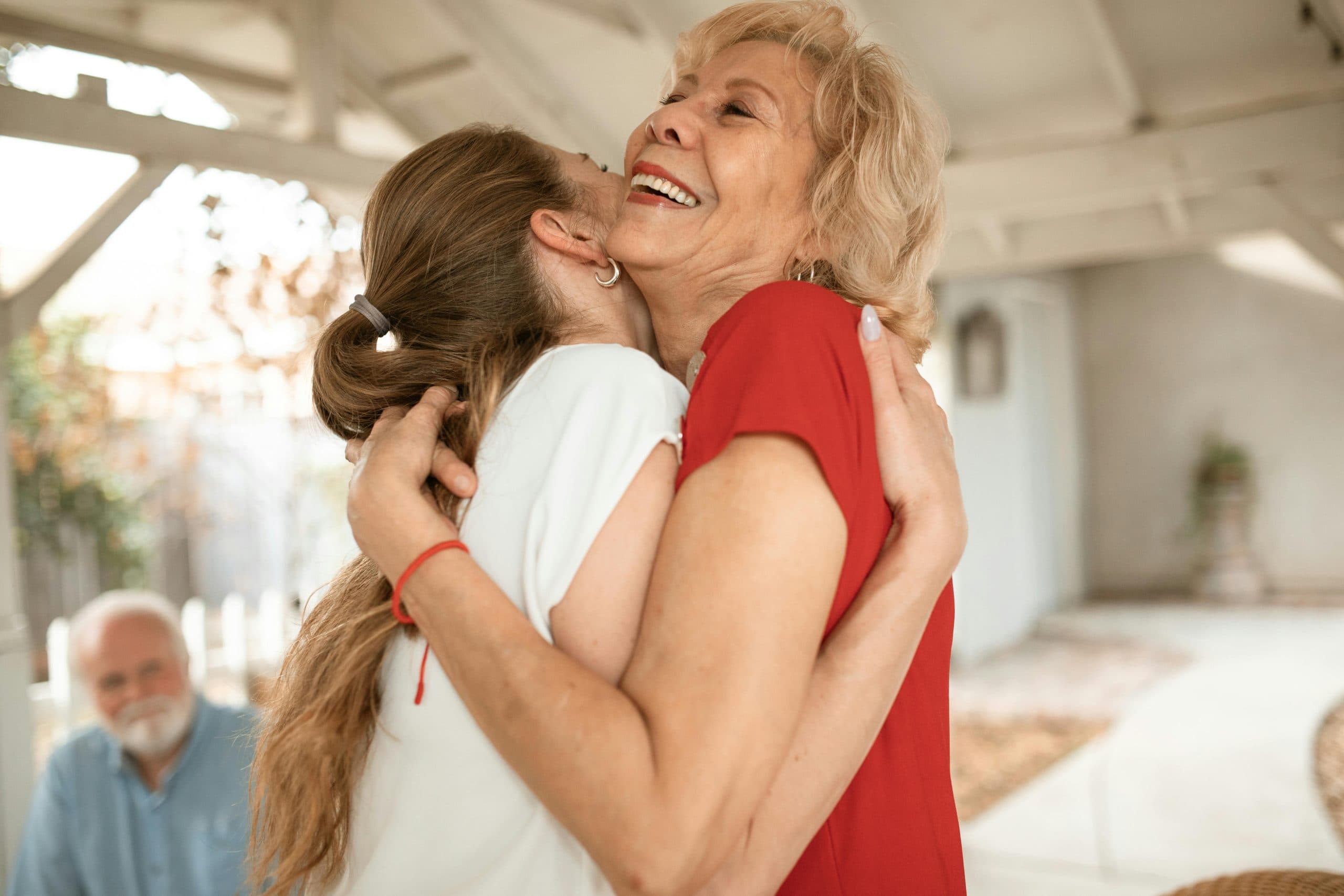 A grandmother embracing her family after the arrival of a new grandchild
