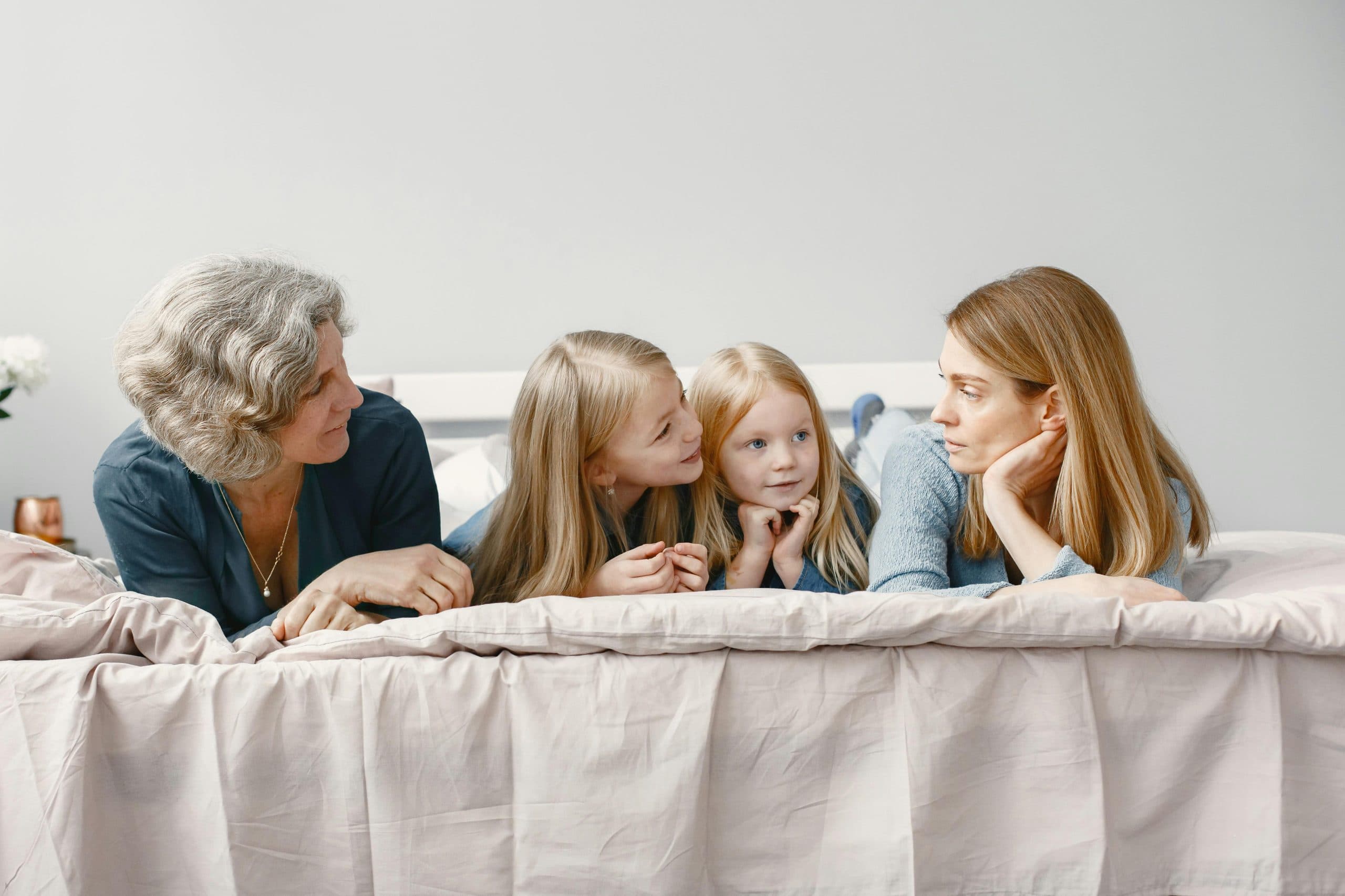 A grandmother laughing with her adult children and grandchildren